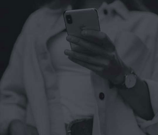 black and white image of a person holding phone