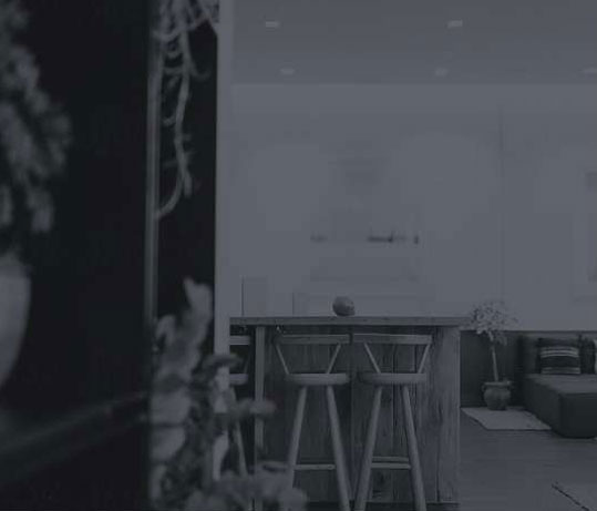 black and white image of a countertop and stools